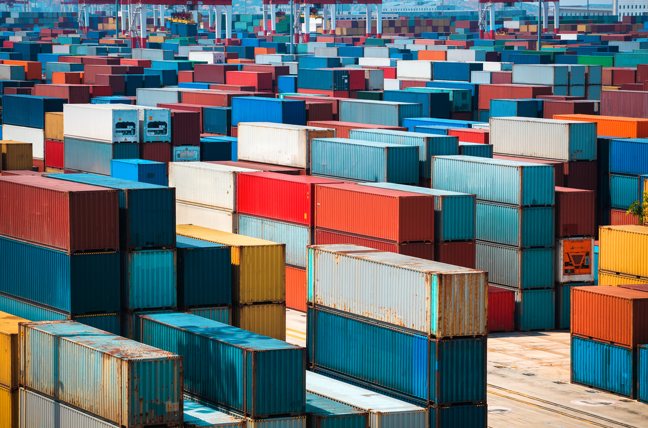 Dos camiones en direcciones opuestas cargando mercancías, diferencias entre exportaciones e importaciones en comercio exterior